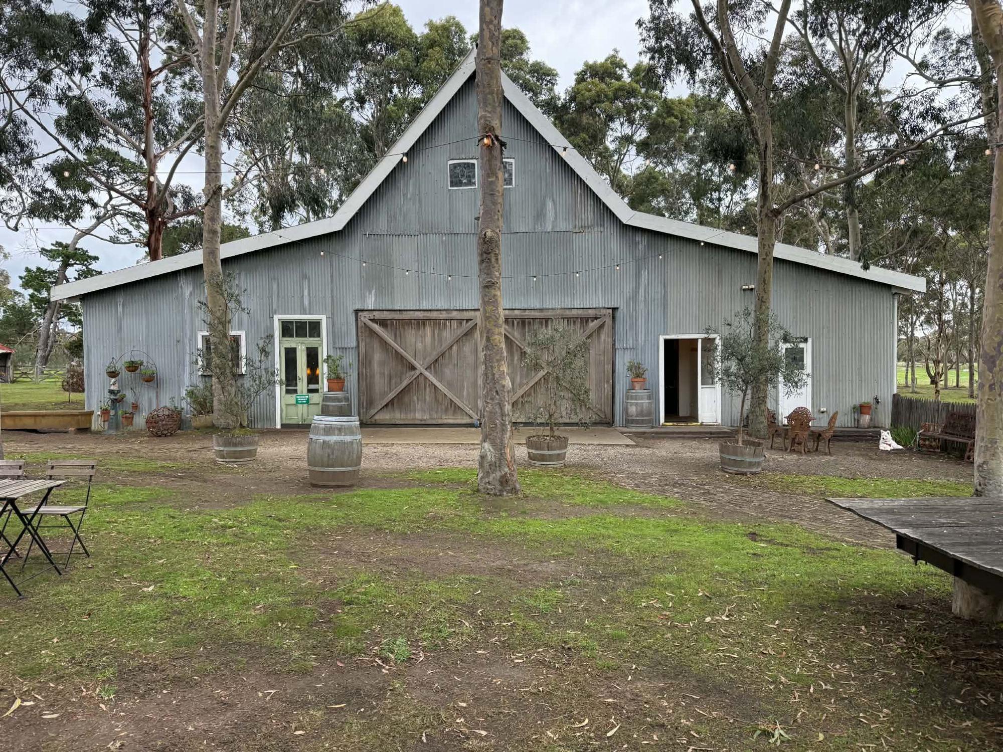 The front of Ivory Barn with wine barrels